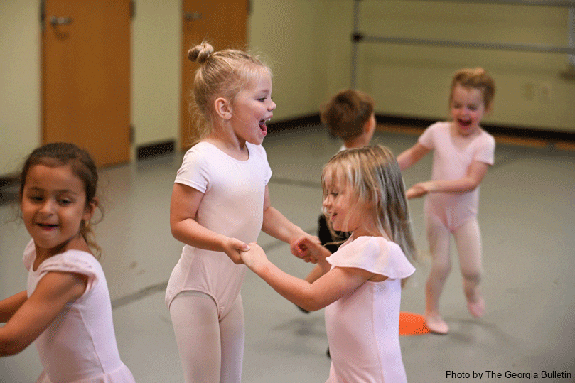Avery McClure, left, and Mary Ruth McNeil, right, dance together during the partner portion of the beginner ballet class at St. Catherine of Siena Church's Dance Academy. The children learn how to work with each other, practice balance and develop musicality during the class.  Photo by Julianna Leopold 