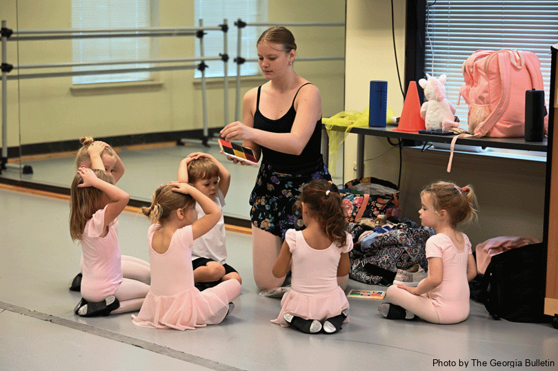 Teacher Anastasia Grantham rewards the children at the end of the beginner ballet class with a stamp on their hands. Grantham is one of the volunteer teachers of St. Catherine of Siena Church's new Dance Academy. Photo by Julianna Leopold