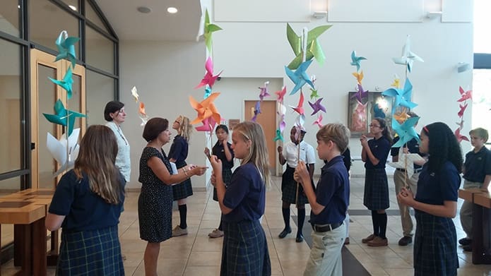 Sixth-grade students at Immaculate Heart of Mary School, Atlanta, process into IHM Church on Friday, Sept. 9, for a prayer service for peace led by Deacon Bob Hauert. He told them peace begins at home and at school with friendship, kindness, and help extended to those who are hurt.