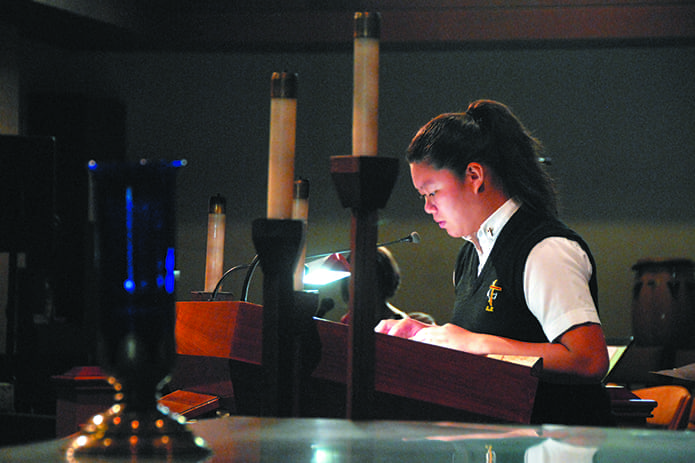 St. John the Evangelist School, Hapeville, student takes part in the school’s Day of Prayer for Peace in our Communities on Friday, Sept. 9. A blue candle has remained lighted at the school since Sept. 11, 2001 and is a beacon of God’s presence and a light of peace and hope. Parents were invited to attend the service online or pause at 10 a.m. to pray for peace wherever they were.