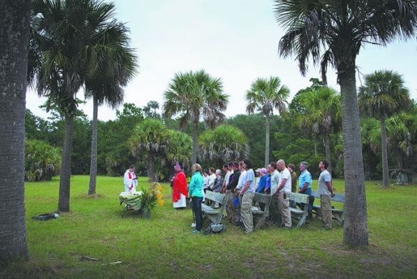Father Mariusz Fuks reads the Gospel as Bishop Gregory J. Hartmayer of Savannah celebrates Mass at the Santa Catalina de Guale mission site on St. Catherines Island in Georgia Oct. 14. It was the bishop's first visit to the site of the oldest church in Georgia. The mission dates back to the 1570s and has been the subject of study by archaeologists for nearly three decades. Scientists on the island continue to excavate with a sense of urgency as erosion from rising sea levels threaten the remains of a vanished American Indian community. CNS photo/Nancy Phelan Wiechec