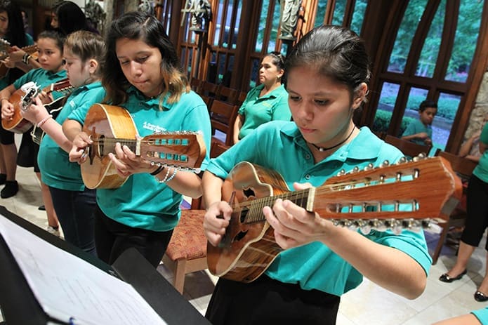 (R-l) Brittany Ramirez, 13, her sister Elsa, 17, Sareli Contreras, 10 and Gabby Iniguez, 11, were four of the seven mandolin players performing with the choir. Brittany and Elsa learned how to play the instrument four years ago, while Sareli and Gabby picked it up a year ago. Photo By Michael Alexander