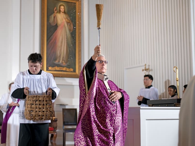 Archbishop Gregory J. Hartmayer, OFM Conv., sprinkles the church with holy water during the dedication service at Divine Mercy Mission. Photo by Johnathon Kelso