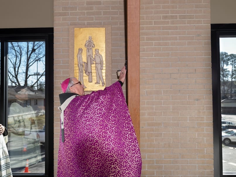 Archbishop Gregory J. Hartmayer, OFM Conv., blesses the walls of the church during the dedication service at Divine Mercy Mission. Photo by Johnathon Kelso