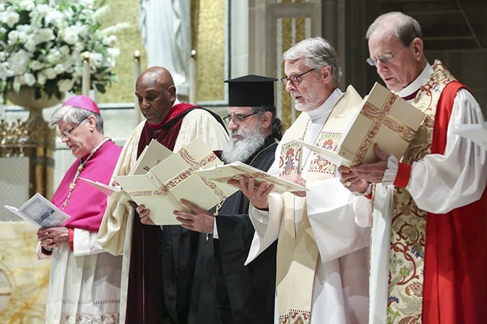 (L-r) Bishop Bernard E. Shlesinger III; Rev. Dr. Gerald Durley, pastor emeritus of Providence Missionary Baptist Church, Atlanta; Father Panayiotis Papageorgiou, Ph.D., presiding presbyter of Holy Transfiguration Greek Orthodox Church, Marietta; Evangelical Lutheran Church in America Bishop H. Julian Gordy; and retired Assisting Episcopal Bishop Don Wimberly join the congregation in singing “I Want Jesus To Walk With Me.” The April 23 Ecumenical Prayer Service took place at the Cathedral of Christ the King, Atlanta. Photo By Michael Alexander