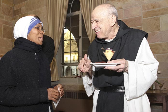 Missionaries of Charity Sister Leo Grace, left, introduces herself to Order of Cistercians of the Strict Observance monk Father Eduardo Rodriguez during a Year of Consecrated Life reception at the Monastery of the Holy Spirit in Conyers. 2015 was the Year of Consecrated Life worldwide. Photo By Michael Alexander