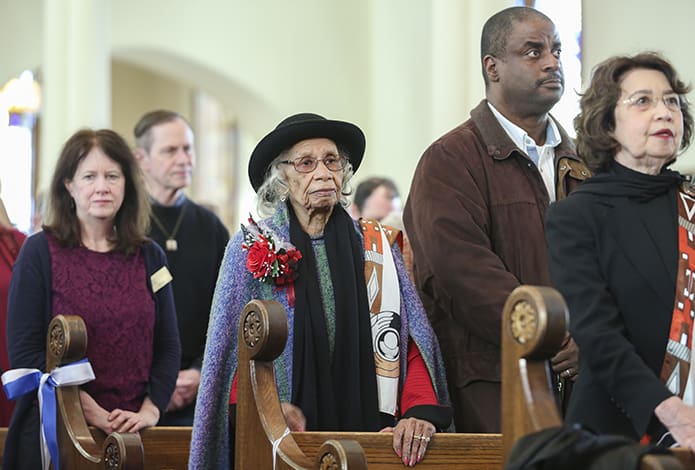 Emily Milner, center, stands with youngest grandchild, Melvin Denham of Orlando, Fla., during the 11 a.m. Mass at the Shrine of the Immaculate Conception, Atlanta. The Jan. 14 liturgy set aside time to recognize Milner four days before her 100th birthday. Photo By Michael Alexander