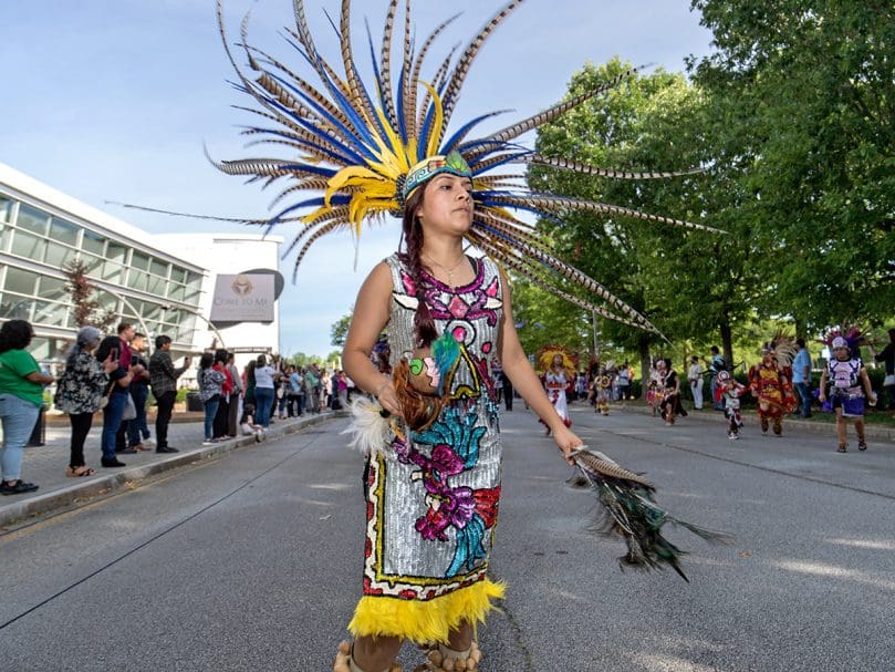 An Aztec dancer performs during the morning procession outside the Georgia International Convention Center in College Park. The Congress returned after a two-year break. Photo by Johnathon Kelso