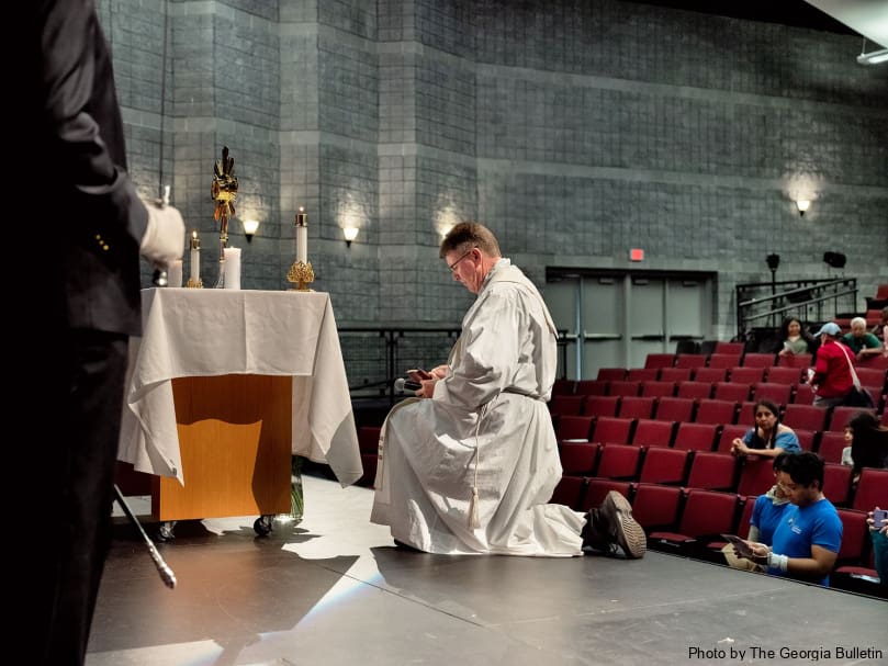 Father Mark McCormick of the Diocese of Rapid City  kneels before the Blessed Sacrament at adoration in Fayetteville. Father McCormick was accompanying the Perpetual Pilgrims on the St. Juan Diego Route as it made its way through Atlanta. Photo by Johnathon Kelso