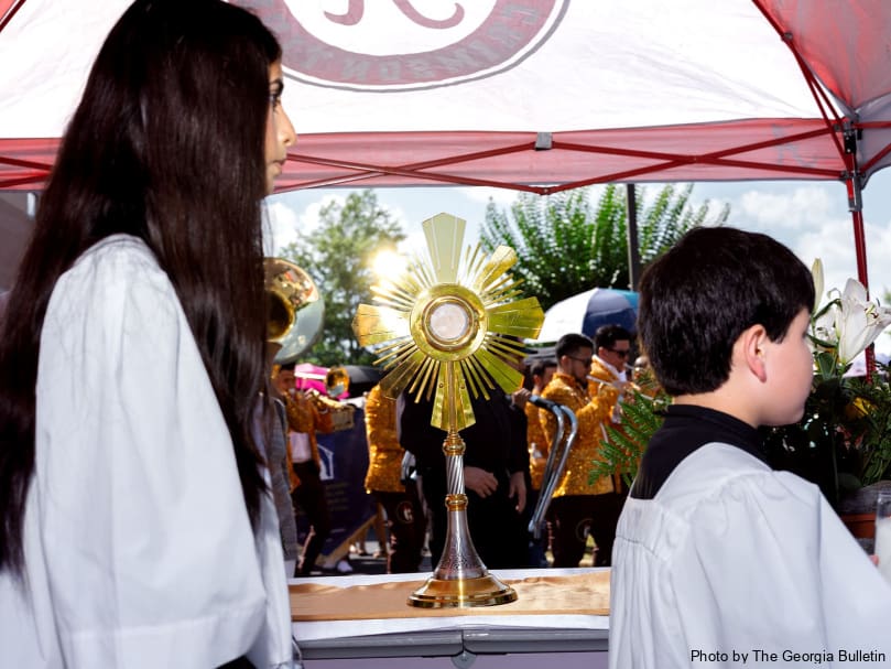 Altar servers walk past the Blessed Sacrament during a Eucharistic Pilgrimage stop at St. Joseph Church in Dalton. Photo by Johnathon Kelso