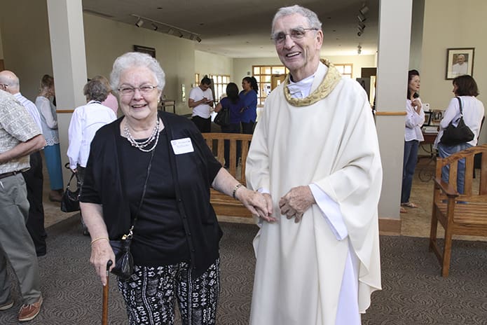 Father Edward O’Connor, right, greets Holy Cross Church parishioner Mary Ann Williams following the 50th anniversary Mass honoring the Atlanta parish’s founders and former pastors. Father O’Connor, who was the pastor at Holy Cross from 1973 to 1976, died Nov. 7. Photo By Michael Alexander