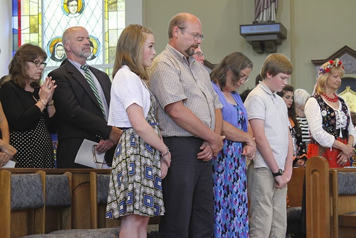 Friends and parishioners of Father Paul Flood attend the May 30 Mass marking his 25th anniversary of priestly ordination. Those on hand included (l-r) Trisha and Dennis Kelly from St. John Neumann Church, Lilburn, Kara Borgelt of St. Francis of Assisi Church, Cartersville, her father Tim, her mother Debi and her younger brother Noah. Photo By Michael Alexander