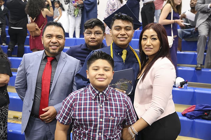 (Clockwise, starting back row, second from right) Cristo Rey graduate Carlos Ramirez celebrates the occasion with his mother Sandra, his brother Fernando, his father Carlos and his brother Joshua. Young Carlos will be attending Ave Maria University, Ave Maria, Fla. Photo By Michael Alexander
