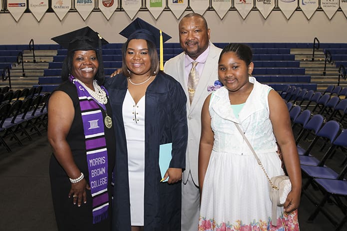 Mya Millines, second from left, joins her mother Monica, her father Reggie and sister Eyana for a post-graduation photograph. Earlier in the day her mother graduated from Morris Brown College, Atlanta, with a Bachelor of Science degree in organizational management and leadership. Mya will be attending Tennessee State University, Nashville, Tenn. Photo By Michael Alexander