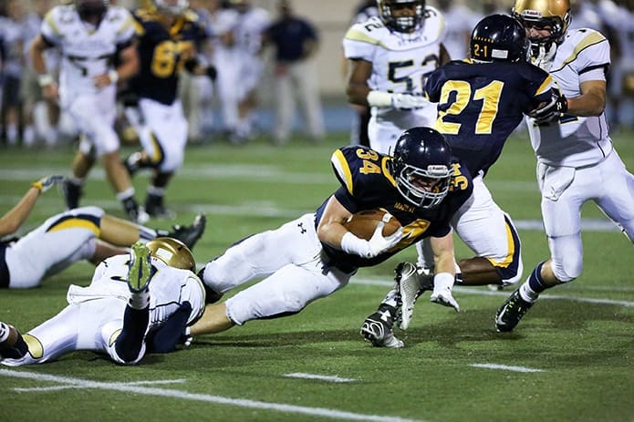 St. Pius cornerback Grant Holloman (#3) trips up Marist running back Griffin King (#34) during the Oct. 10 game at Marist Schoolâs Hughes Spalding Stadium. Photo By Rob Buechner