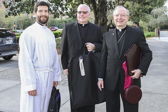Bishop-designate Joel M. Konzen, SM, right, arrives for the solemn vespers service in his honor. He is joined by (l-r) Father Daniel Ketter, the Archdiocese of Atlanta’s judicial vicar in the Metropolitan Tribunal, and Father John Kinney, United States Air Force chaplain. Father Ketter is a 1988 graduate of Marist School, Atlanta. Father Kinney and Konzen’s friendship dates back to 1968, when they were classmates at St. Meinrad College, Indiana. Photo By Michael Alexander
