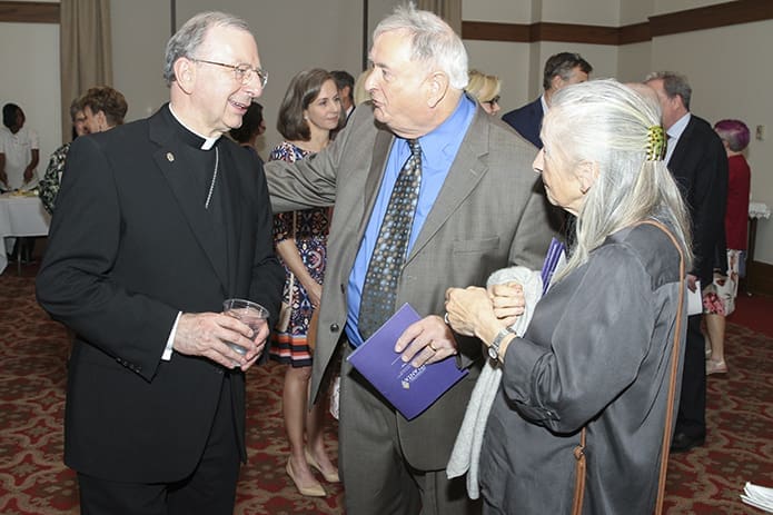 During the post-vespers reception, Bishop-designate Joel M. Konzen, SM, chats with John Hermes, center, a childhood friend since grade school from Oak Harbor, Ohio, and Hermes’ sister Ceil. Photo By Michael Alexander
