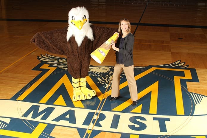 Angela Gentile Elledge, right, poses with the current Marist School War Eagle mascot Katherine Robb. In 1986 Elledge donned the school’s first full body mascot costume. Photo By Michael Alexander