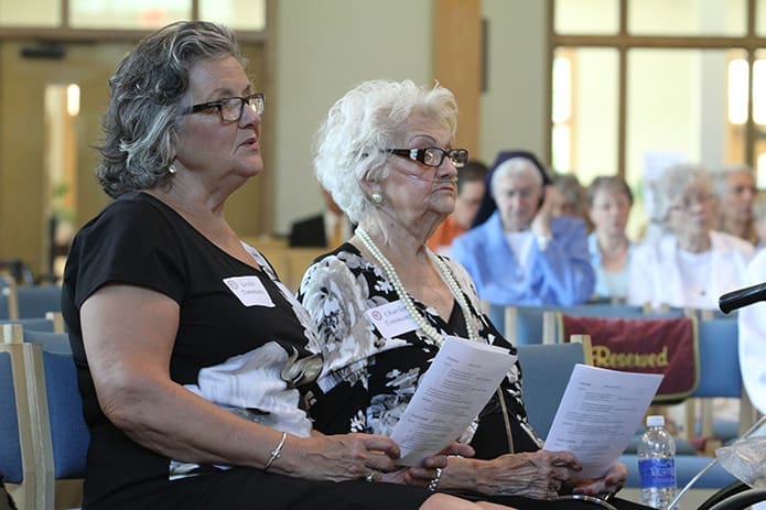 Leslie Timmons, left, and her mother Charlene, who joined the Holy Cross Church in 1968, attend the 50th anniversary Mass honoring its founders and former pastors. Photo By Michael Alexander