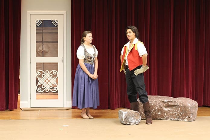 The Holy Cross Church theater ministry rehearses for its production of Disneyâs Beauty and the Beast Jr. during its drama camp. In this scene Gaston, played by Mario Flamenco, 15, proposes to Belle, played by Shea Jones, 14. The proceeds from the three productions, the weekend of July 18-20, benefited the parishâs St. Martin de Porres food pantry. Photo By Michael Alexander