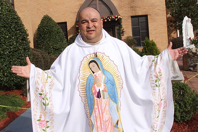 Father Carlos Bustamante, parochial vicar at Our Lady of the Americas Mission, shows off the special vestment he wore on the feast of Our Lady of Guadalupe. Photo By Michael Alexander