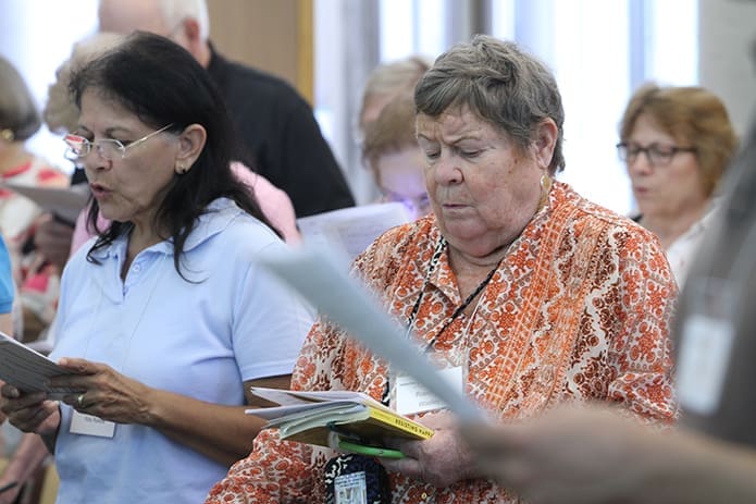 (R-l) Rosemary Woolley of St. Jude the Apostle Church, Sandy Springs, and Vicky Ruberté of St. Monica Church, Duluth, pray with others during the afternoon vespers service at Ignatius House Jesuit Retreat Center, Atlanta, July 31. Photo By Michael Alexander
