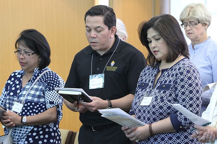 (L-r) Mae Penaflorida from the Church of St. Ann, Marietta, and Deacon Rick and Christy Medina from All Saints Church, Dunwoody, also pray with others during the afternoon vespers service. Photo By Michael Alexander