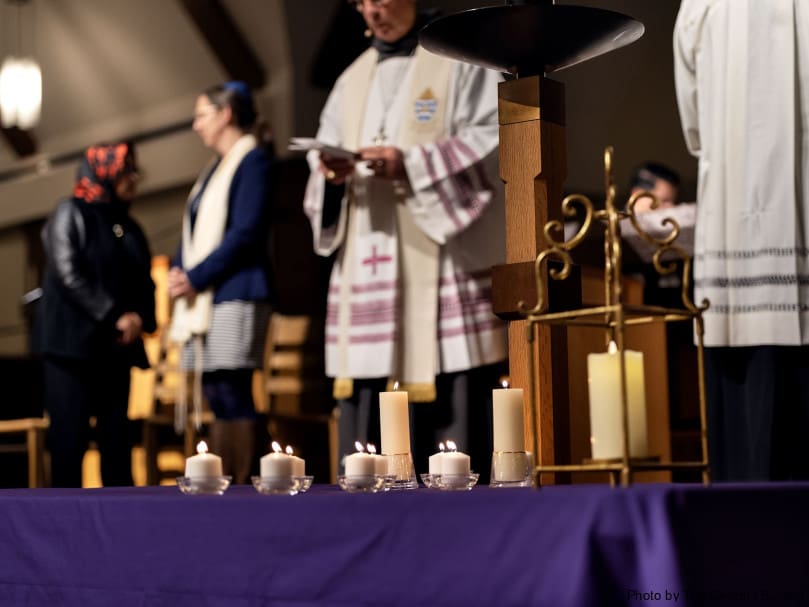 Candles lit by the altar during an Ecumenical  and Interreligious Prayer Service at Immaculate Heart of Mary Church. Photo by Johnathon Kelso