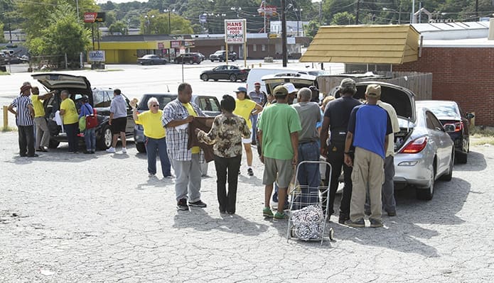 The final stop, in a parking lot just off Donald Lee Hollowell Parkway, on James Jackson Parkway, NW, usually draws the largest number of people needing food and clothing. Photo By Michael Alexander