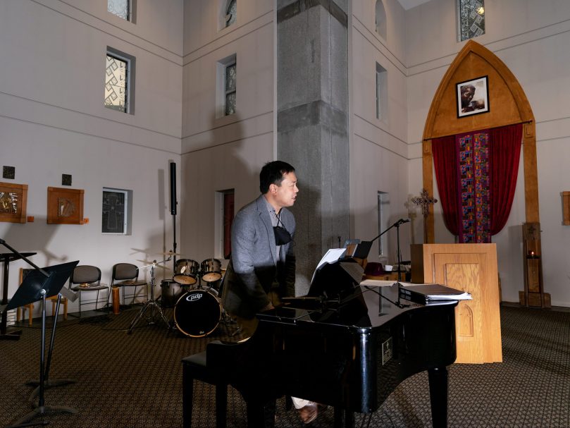 Dr. Joseph Legaspi, director of the Bowman Scholars Program, plays the piano during rehearsal the evening before the Lessons and Carols event at Lyke House. Photo by Johnathon Kelso