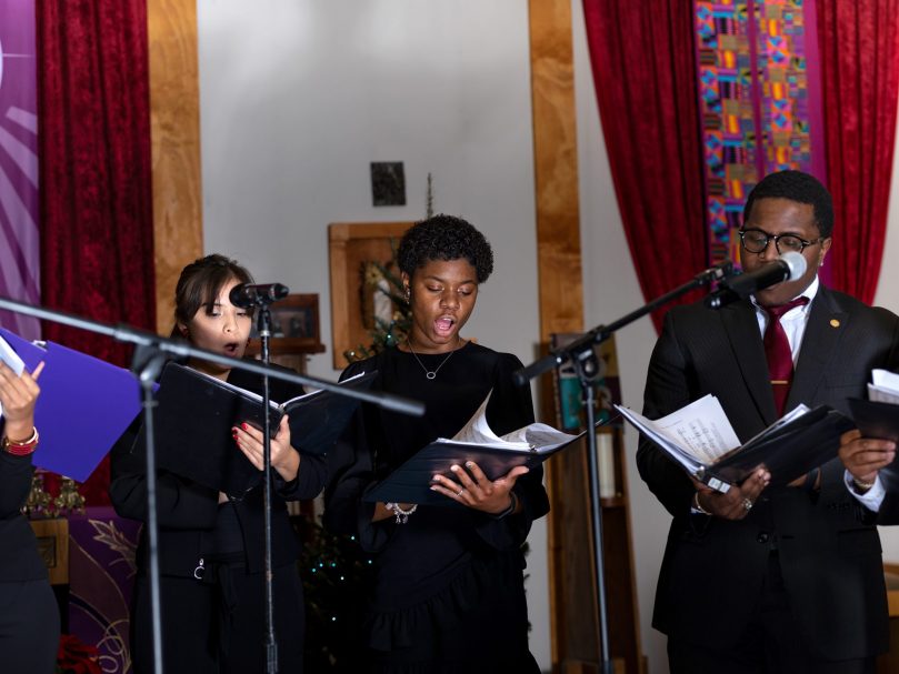 Thea Bowman Scholar Margaret Quartey , center, sings during the Lessons & Carols event hosted at the Lyke House. Photo by Johnathon Kelso