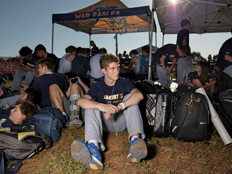 Marist cross-country runner Brendan Botters sits with teammates before the races of the Wingfoot XC Classic in Cartersville on Sept. 23. Photo by Johnathon Kelso