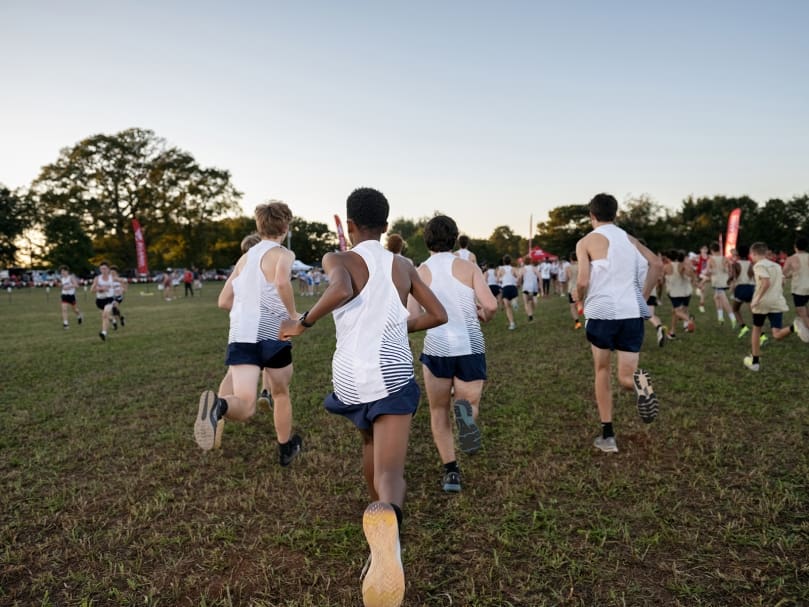 The junior varsity championship boys warm up before the first race of the evening at the Wingfoot XC Classic at Cartersville's Sam Smith Park. Photo by Johnathon Kelso
