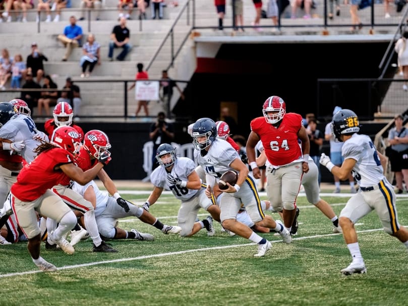 Marist quarterback Ian White breaks away for a play against Woodward Academy during the second quarter of the game on Sept. 9. Photo by Johnathon Kelso