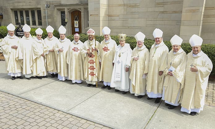 All the bishops on hand for the episcopal ordination of Bishop-designate Joel M. Konzen, SM, sixth from the left, gather for a group photo on the cathedral plaza. They include (l-r) Bishop Peter Joseph Jugis (Diocese of Charlotte), Bishop Gregory J. Hartmayer, OFM Conv. (Diocese of Savannah), Bishop Luis Rafael Zarama (Diocese of Raleigh), Bishop Robert Joseph Baker (Diocese of Birmingham), Archbishop Christophe Pierre, the Apostolic Nuncio to the United States, Archbishop Wilton D. Gregory, Bishop Bernard E. Shlesinger III, Bishop Kurt Burnette (Byzantine Catholic Eparchy of Passaic, Woodland Park, N.J.), Bishop Emeritus J. Kevin Boland (Diocese of Savannah), Archbishop Thomas J. Rodi (Archdiocese of Mobile), Auxiliary Bishop Denis J. Madden (Archdiocese of Baltimore) and Bishop Robert Guglielmone (Diocese of Charleston, S.C.). Photo By Michael Alexander