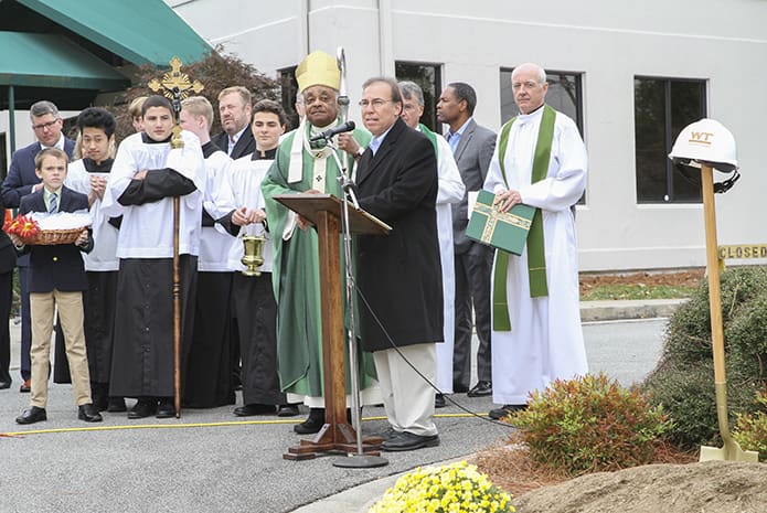 Building committee member Paul Bataillon shares some opening remarks during the Oct. 29 groundbreaking ceremony at Mary Our Queen Church, Norcross. Clergy looking on include (l-r) Archbishop Wilton D. Gregory, former pastor Father David Dye and current pastor Father Darragh Griffith. Photo By Michael Alexander