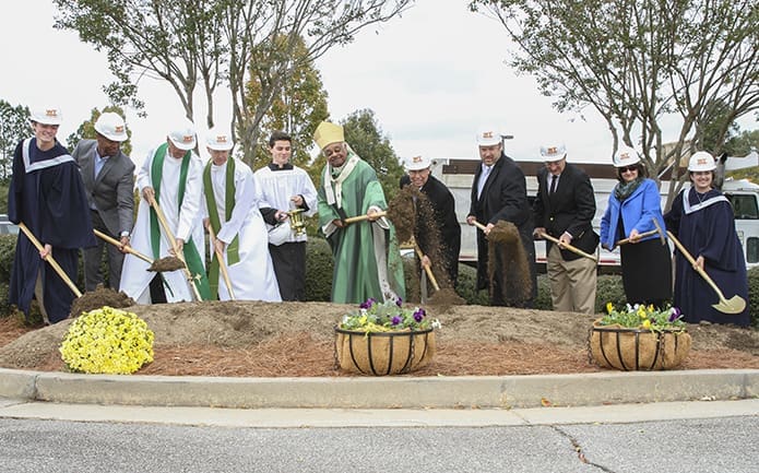 During the Oct. 29 groundbreaking ceremony at Mary Our Queen Church, Norcross, (l-r) Trenton Phillips, Carrington Moultrie of Catholic Construction Services, former pastor Father David Dye, current pastor Father Darragh Griffith, Archbishop Wilton D. Gregory, building committee member Paul Bataillon, Michael Briselden of Whiting-Turner Contracting Co., John Schiavone of Catholic Construction Services, building committee member Joann Manka and Collette Cassar participate in the ceremonial dirt toss. Photo By Michael Alexander