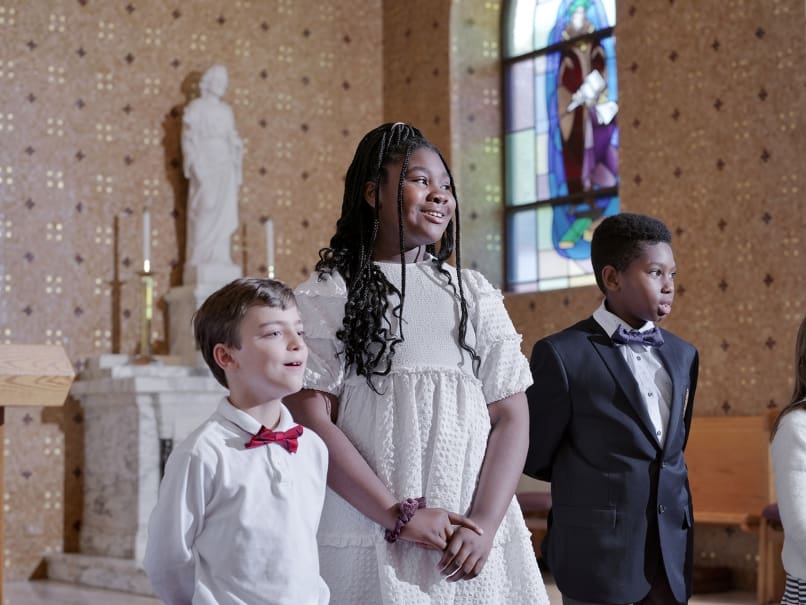 Fifth-grade students at St. Thomas More School perform songs for their mothers during a May Crowning and Mother's Day Mass held at the church on May 3.  From left to right are  Elliot Ramer, Marley Madden, and Trey Thomas. Photo by Johnathon Kelso