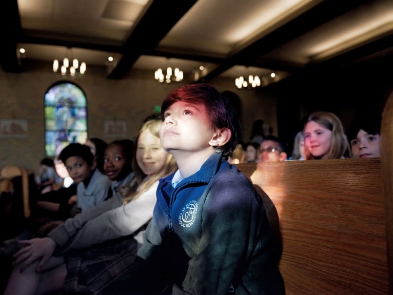Jonah Eldaif, third grader,  looks to the light during a May Crowning and Mother's Day Mass held at St. Thomas More church on May 3. Photo by Johnathon Kelso