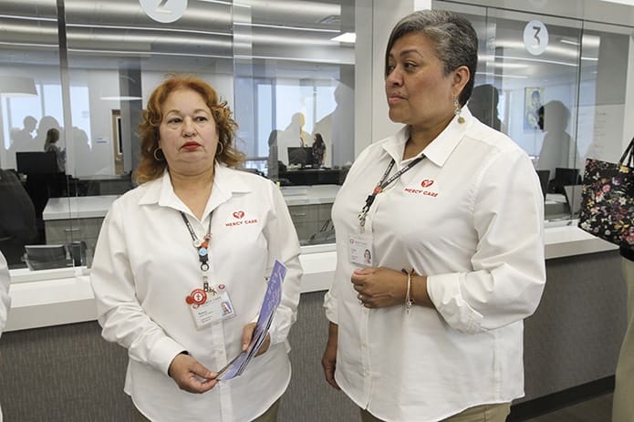 Medical office specialists Nancy Lopez De Victoria, left, and Farley Diaz were two of the several Mercy Care Chamblee Clinic staff on hand for the May 1 dedication and reception. Photo By Michael Alexander