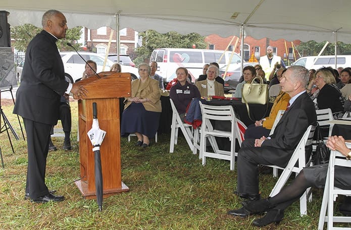 Standing before benefactors, special guests and employees of Mercy Care, Archbishop Wilton D. Gregory shares some words and conducts a prayer for the project. Photo By Michael Alexander