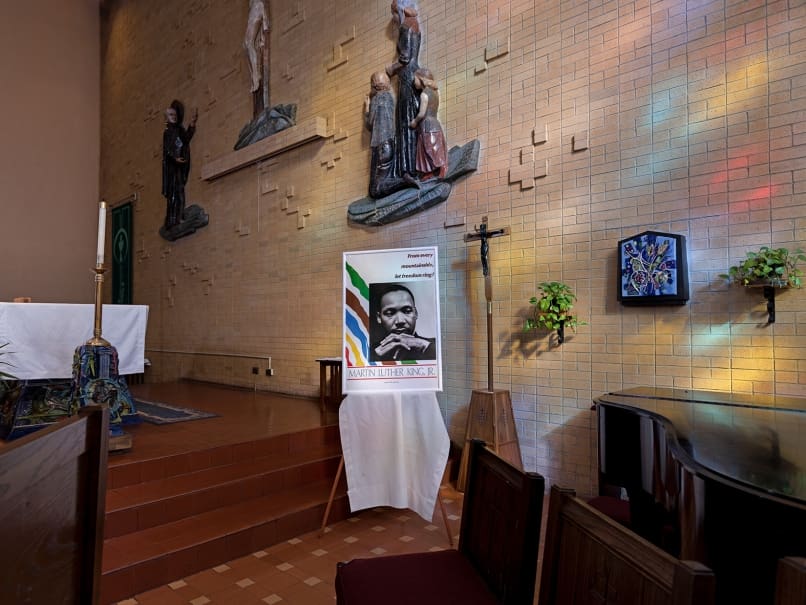 A framed poster of Martin Luther King Jr. is placed near the altar during a Mass in his honor at St. Paul of the Cross Church Jan. 14. Photo by Johnathon Kelso