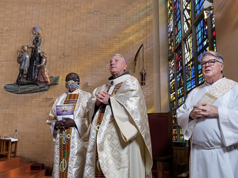 Archbishop Gregory J. Hartmayer, OFM Conv., center, stands with Deacon Lennison “Lenny” Alexander of Our Lady of Lourdes Church, left, and Deacon Dennis Dorner, right, at a Mass in honor of Martin Luther King Jr. The Jan. 14 Mass was at St. Paul of the Cross Church. Photo by Johnathon Kelso