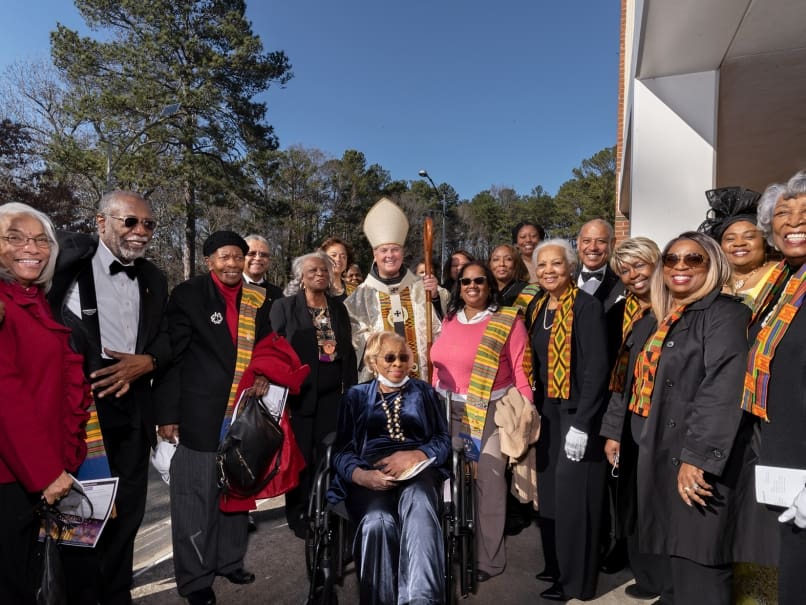 Archbishop Gregory J. Hartmayer, OFM Conv., center, visits with members of the Knights of Peter Claver and its Ladies Auxiliary outside St. Paul of the Cross Church. Photo by Johnathon Kelso