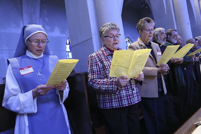 (L-r) Sister Mary Beatrice Raphael and Congregation of Our Lady of the Retreat in the Cenacle Sisters Susan Arcaro and Barbara Young pray with other consecrated religious during the evening liturgy of praise, the Divine Office of Vespers. Photo by Michael Alexander