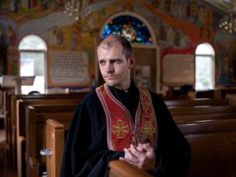 Father Volodymyr Petrytsya sits and prays inside Mother of God Ukrainian Catholic Church in Conyers. “There are no words to describe. There is lots of pain for all the people who suffer unjustly,” said the priest about the invasion of his home country by Russia. Photo by Johnathon Kelso