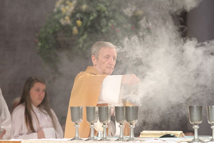 When Msgr. Patrick Bishop censes the altar just before the Liturgy of the Eucharist, it’s like a balletic, liturgical exercise. The May 17 Mass took place the day before the 40th anniversary of his ordination to the priesthood. Photo By Michael Alexander