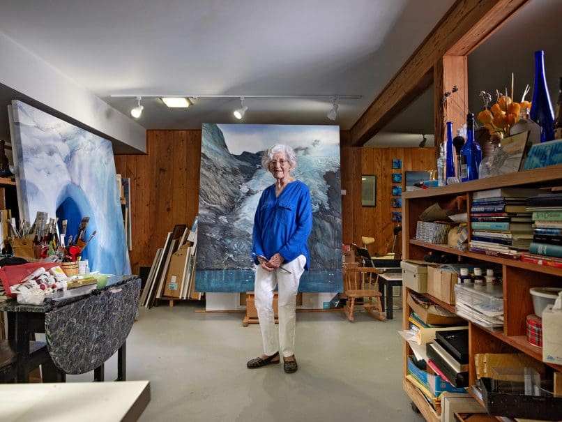 Artist Myrtha Vega stands in her home studio surrounding by her work. Photo by Johnathon Kelso