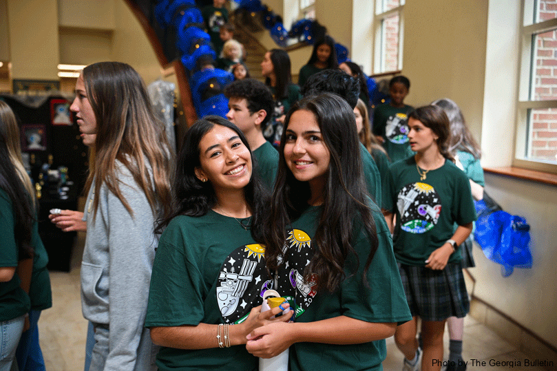 Pinecrest Academy students Isabela Janica, left, and Carina Brousseau,  right, donned their outer space T-shirts Sept. 30 to participate in an assembly to contact NASA astronaut Col. Mike Fincke aboard the International Space Station. Photo by Julianna Leopold