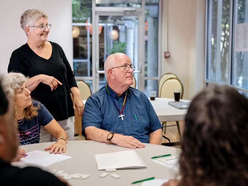 Father Bill Key, center, listens to a participant of the National Deaf Cursillo held at Ignatius House Jesuit Retreat Center in Sandy Springs. Father Key is the Cursillo's spirtual director. Photo by Johnathon Kelso